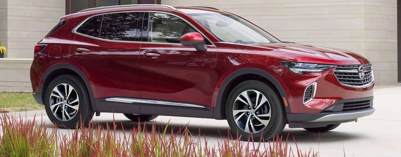 A red 2024 Buick Envision parked in a driveway.