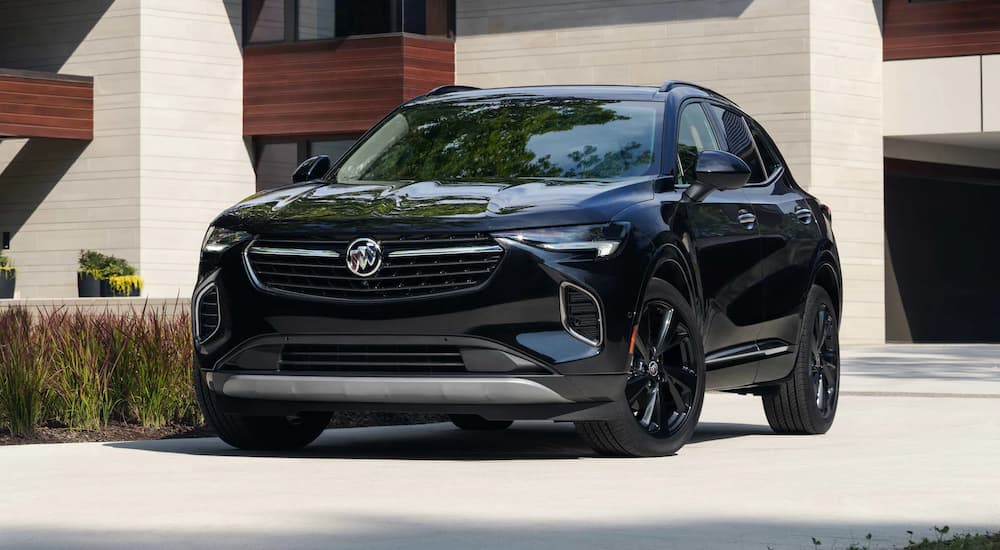 A black 2022 Buick Envision Avenir is shown parked in a driveway after visiting a Buick dealer.