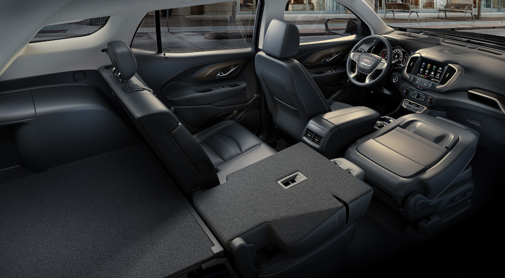 The black interior and fold-flat passenger seat in a 2024 GMC Terrain for sale.