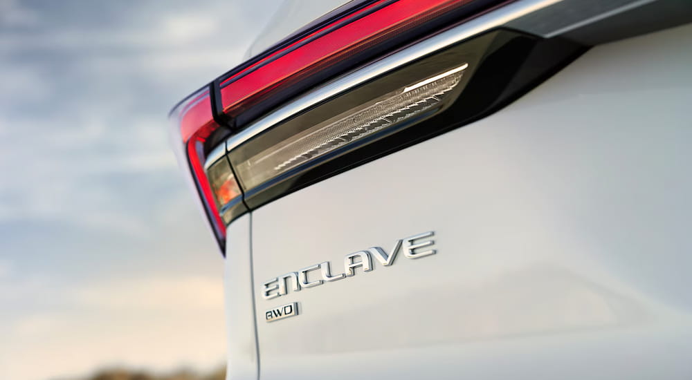 Close-up on the rear badging of a white 2025 Buick Enclave.