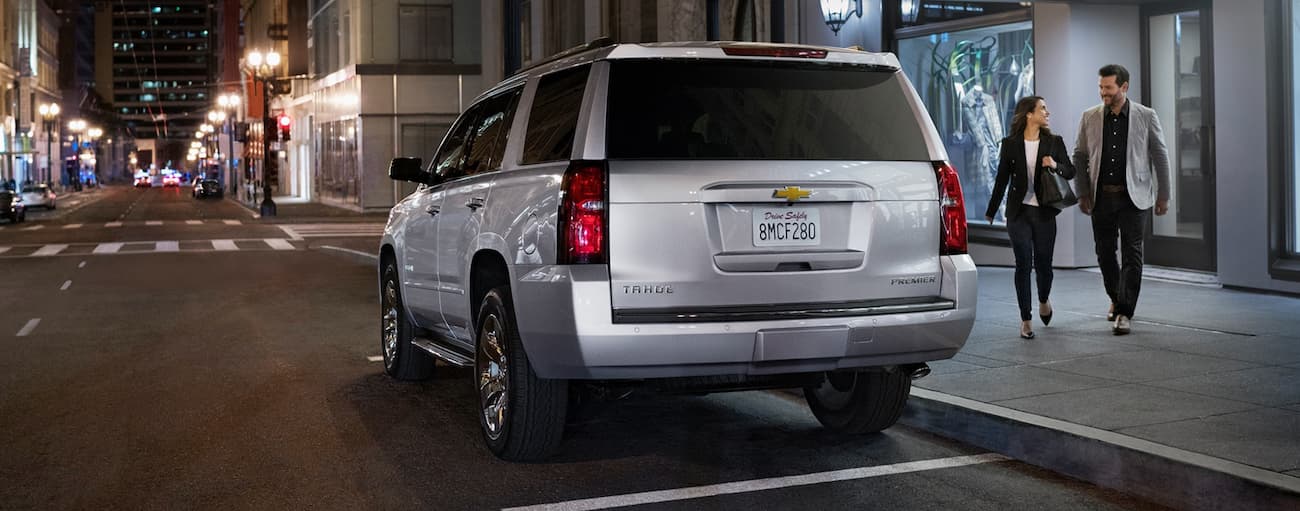 Rear of a white 2020 Chevy Tahoe Premier parked by a curb.