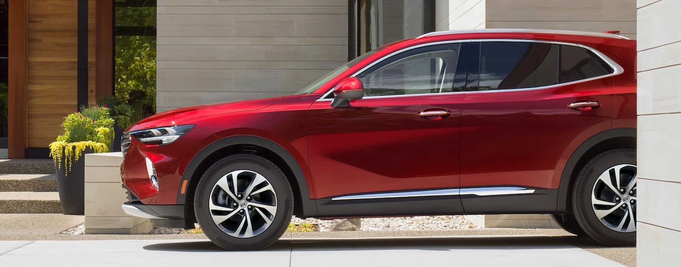 Red 2023 Buick Envision parked in a driveway.