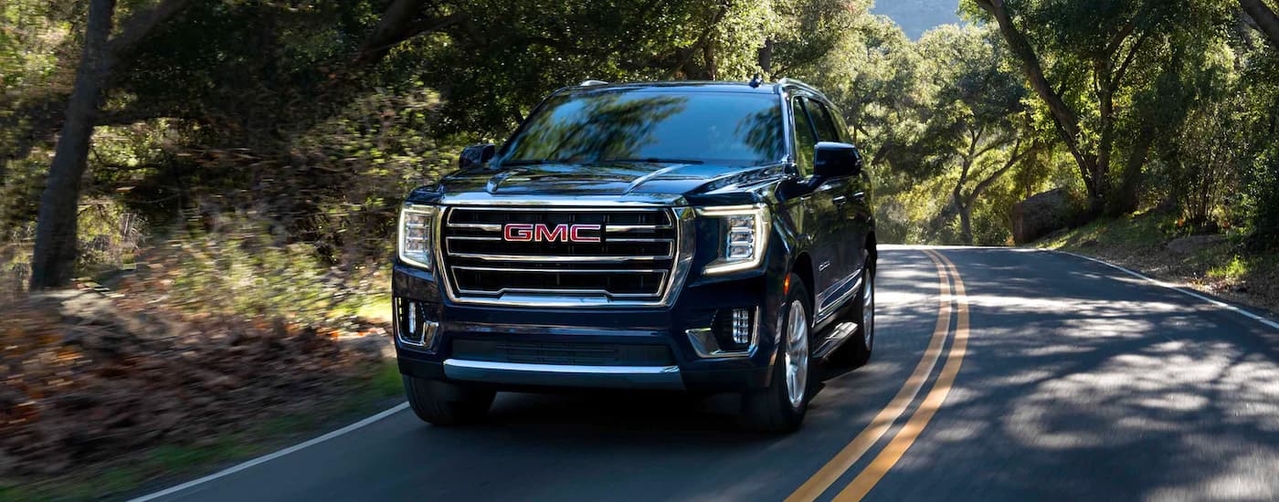 Black 2023 GMC Yukon Denali on a shady road
