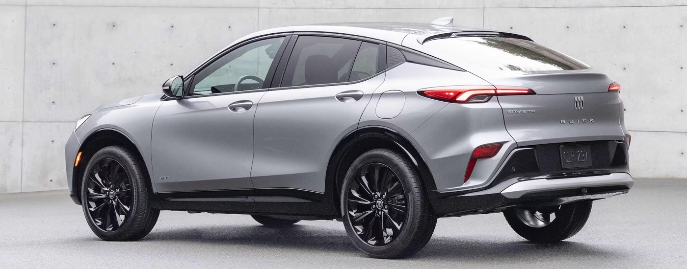 Rear view of a silver 2025 Buick Envista ST at a Buick dealer near Plymouth.