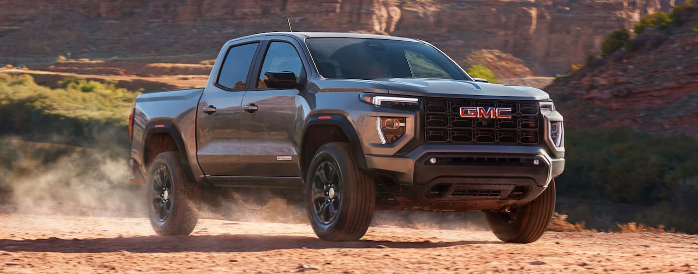 Grey 2025 GMC Canyon driving off-road.