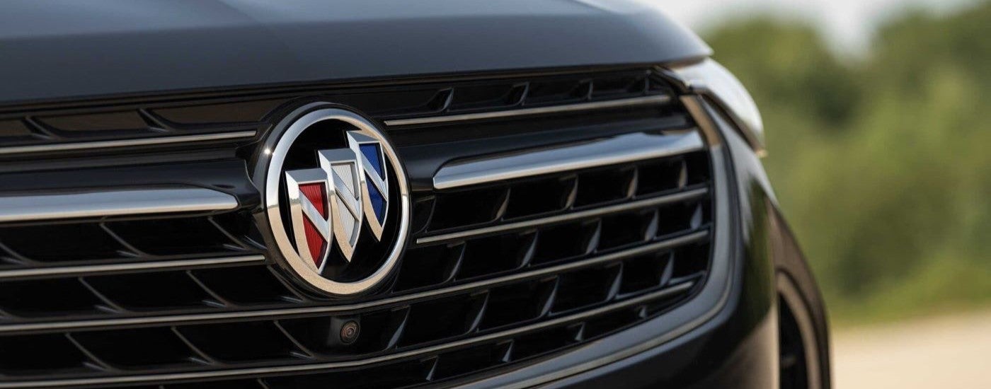 A close-up of the grille on a black 2023 Buick Envision ST is shown.