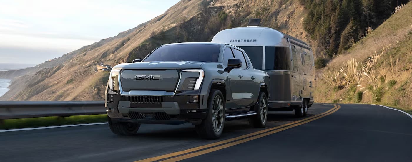 Grey 2025 GMC Sierra EV for sale towing an Airstream cabin.