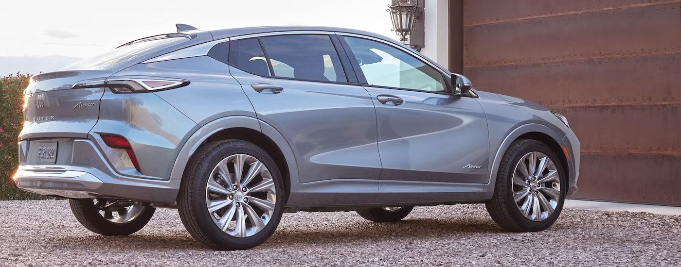 A silver 2024 Buick Envista Avenir is shown from the rear at an angle.