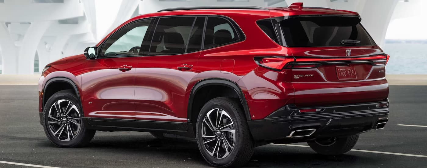 A red 2025 Buick Enclave driving down a road